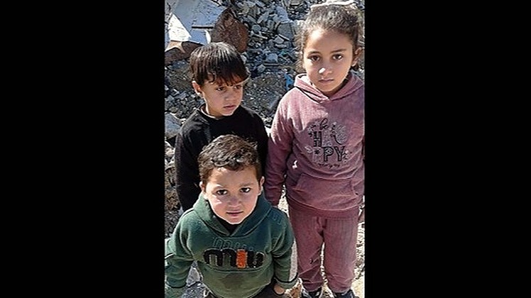 A mother in Gaza is homeless, living in a tent with her young children after losing her home. Her family has no source of income, and they lack food and clothing.